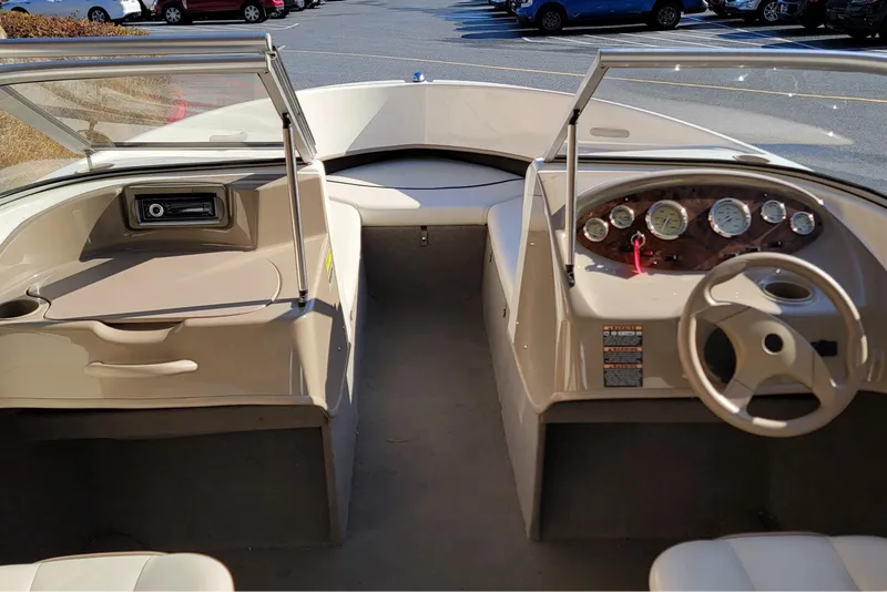 Slide: The Image of 2004 Bayliner 215 Classic boat interior with dashboard and steering wheel. - 5