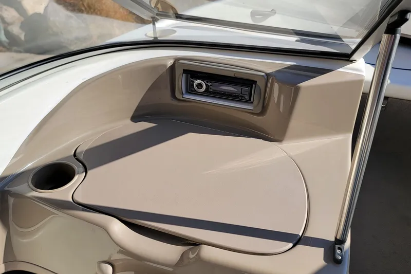 Slide: The Image of 2004 Bayliner 215 Classic boat dashboard with stereo and cup holder. - 9