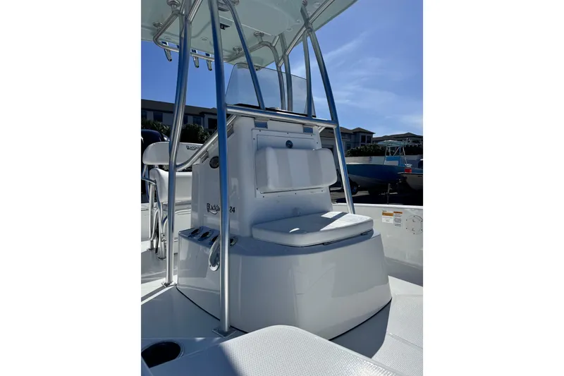 Slide: The Image of 2026 BlackJack 224 boat interior with seating and console under clear blue sky. - 8