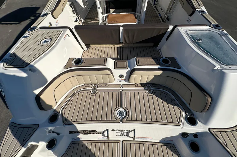 Slide: The Image of 2022 Yamaha Boats 252 FSH Sport interior with cushioned seating and sleek design. - 15