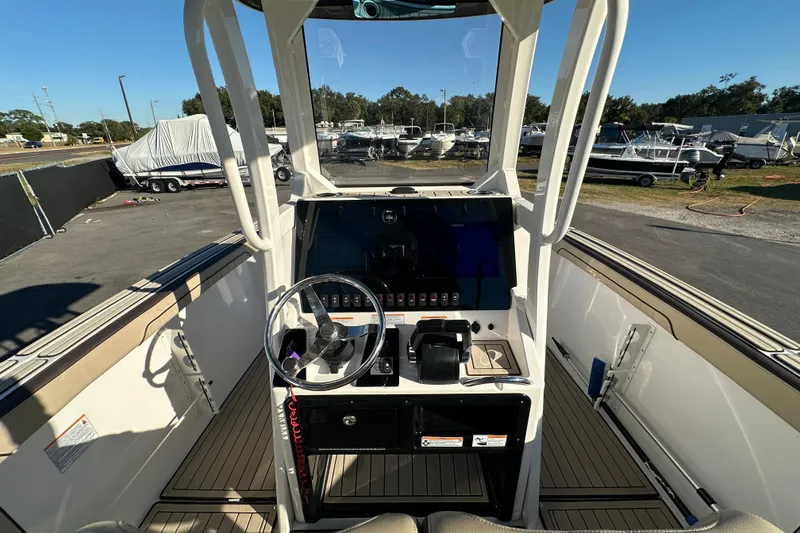 Slide: The Image of 2022 Yamaha Boats 252 FSH Sport cockpit with steering wheel and control panel. - 27