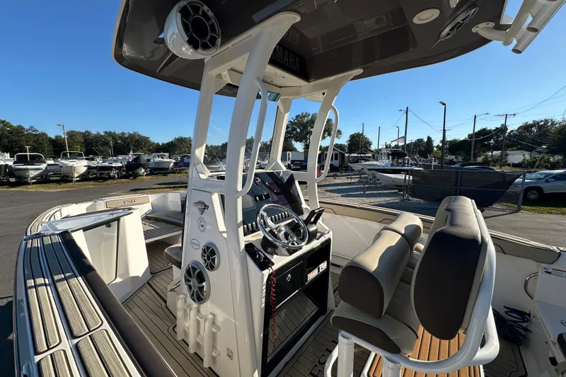 Slide: The Image of 2022 Yamaha Boats 252 FSH Sport interior with helm, seating, and modern controls. - 29