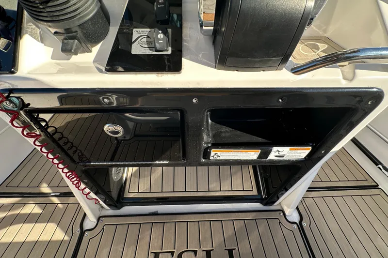 Slide: The Image of Yamaha Boats 2022 252 FSH Sport dashboard with controls and storage compartments. - 46