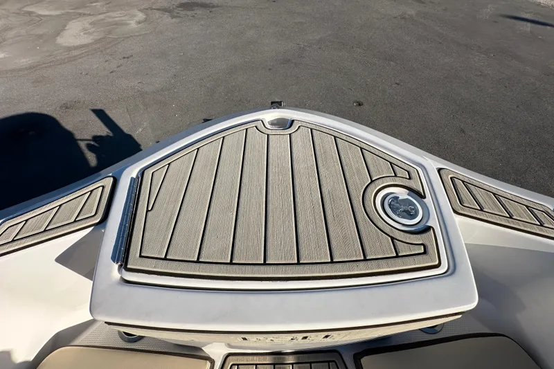 Slide: The Image of 2022 Yamaha Boats 252 FSH Sport bow deck with sleek design and wood finish. - 65