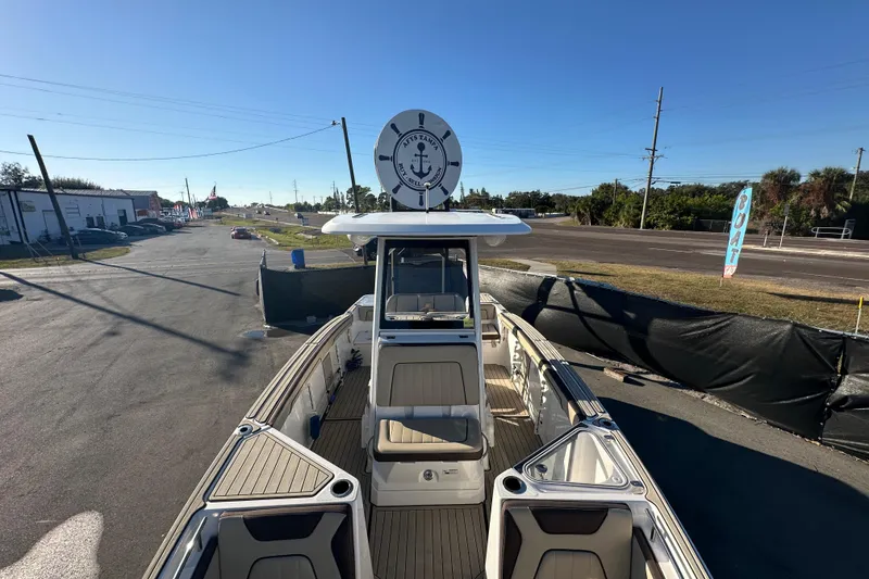 Slide: The Image of 2022 Yamaha Boats 252 FSH Sport, docked, showcasing spacious deck and seating. - 67