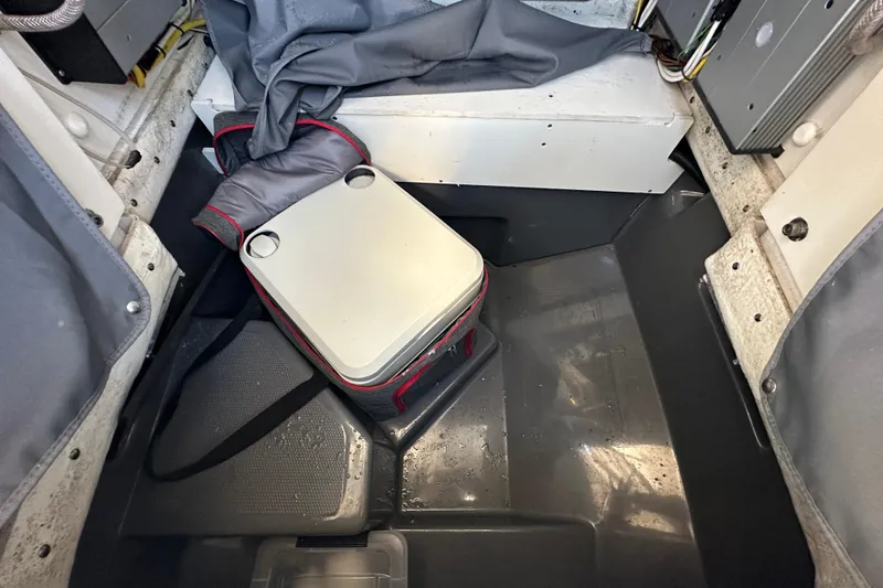 Slide: The Image of 2022 Yamaha Boats 252 FSH Sport interior with storage compartment and cooler. - 87