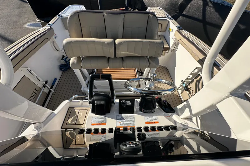 Slide: The Image of 2022 Yamaha Boats 252 FSH Sport cockpit with dual seats and control panel. - 92