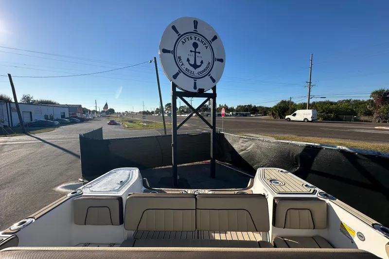 Slide: The Image of 2022 Yamaha Boats 252 FSH Sport at a dealership with a nautical sign. - 99