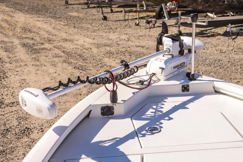 Slide: The Image of 2023 Avid 19 FS boat with Minn Kota trolling motor on sandy shore. - 10