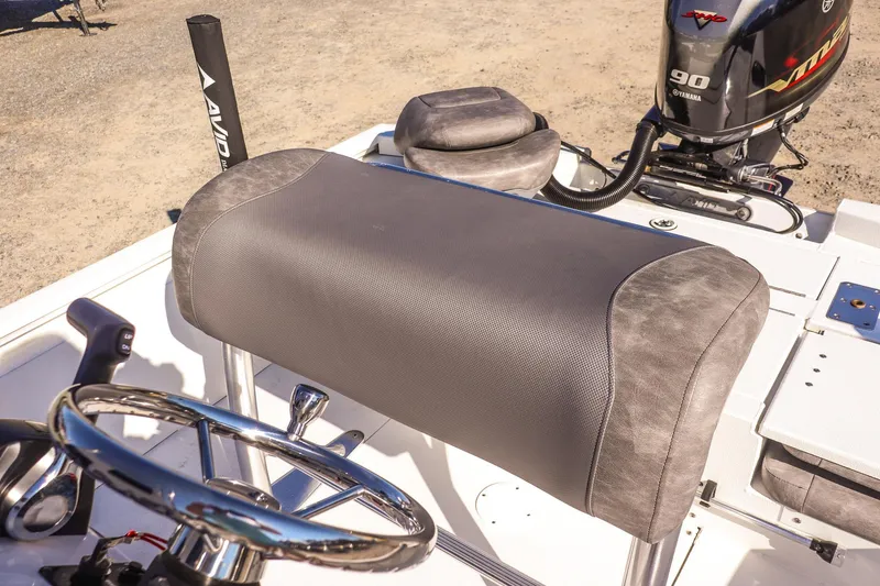 Slide: The Image of 2023 Avid 19 FS boat interior with steering wheel and Yamaha 90 engine. - 11