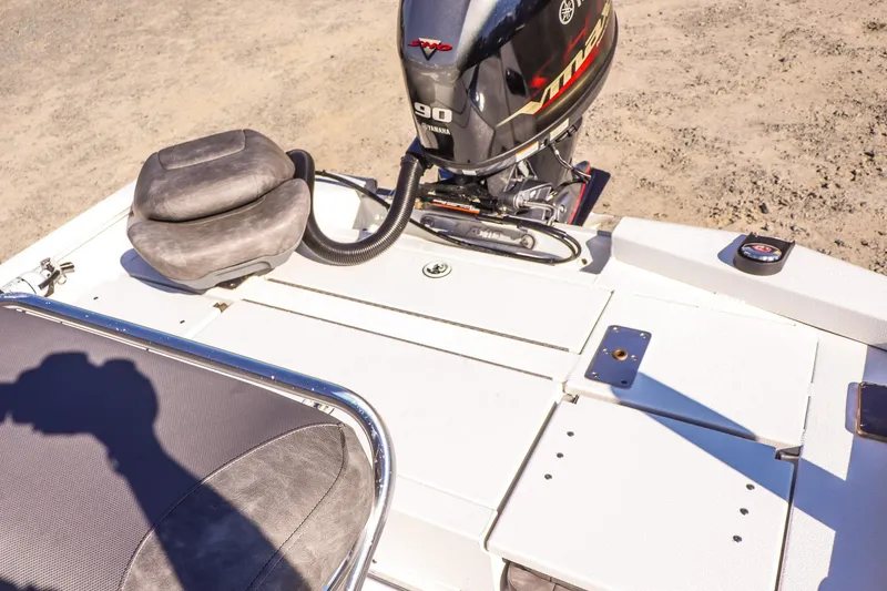 Slide: The Image of 2023 Avid 19 FS boat with Yamaha 90 engine, featuring cushioned seating and storage compartments. - 13