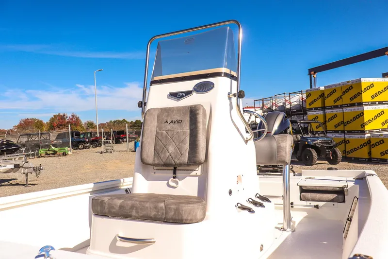 Slide: The Image of 2023 Avid 19 FS boat with console and seating, displayed outdoors under clear blue sky. - 14