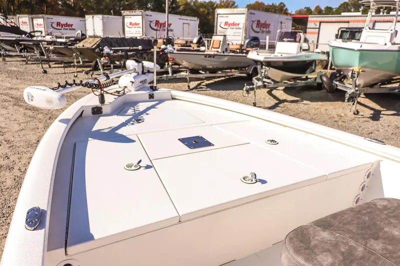 Slide: The Image of 2023 Avid 19 FS boat on display in a dealership lot with trailers. - 15