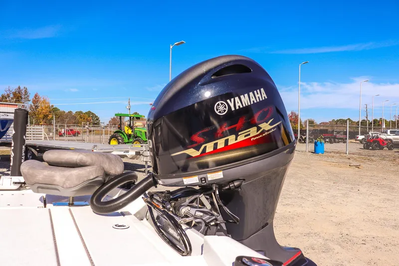 Slide: The Image of 2023 Avid 19 FS boat with Yamaha VMAX outboard motor in a sunny outdoor setting. - 16