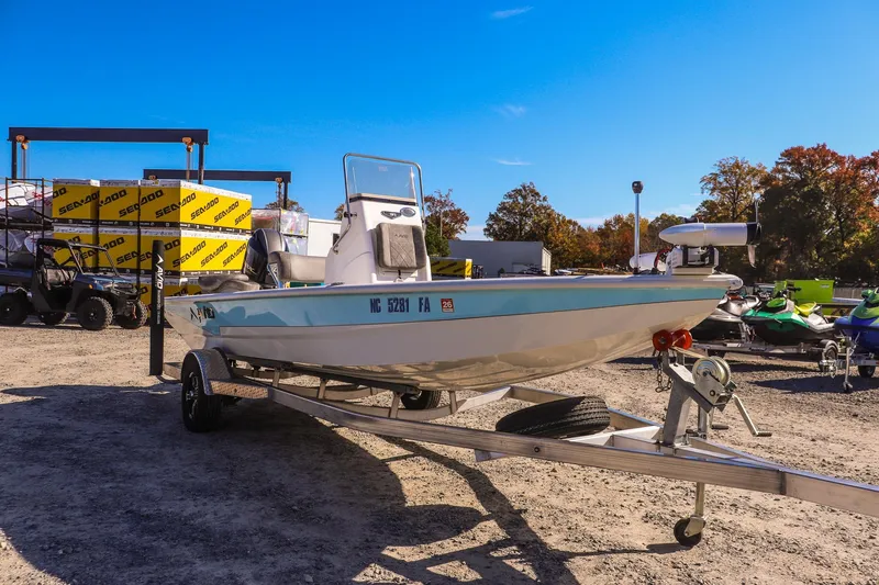 Slide: The Image of 2023 Avid 19 FS boat on trailer in outdoor dealership lot. - 2