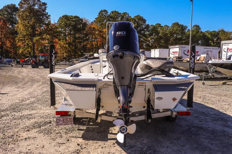 Slide: The Image of 2023 Avid 19 FS boat with outboard motor, parked on a trailer in a lot. - 5