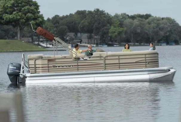 Slide: The Image of 2008 Sanpan 2200 RE-3 Gate pontoon boat on a calm lake with passengers. - 0