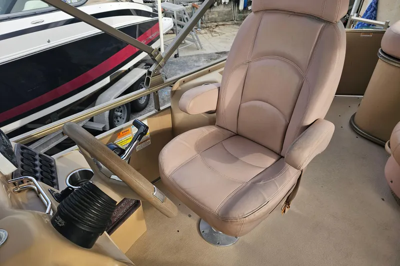 Slide: The Image of Captain's chair on 2008 Sanpan 2200 RE-3 Gate pontoon boat, featuring beige upholstery. - 10