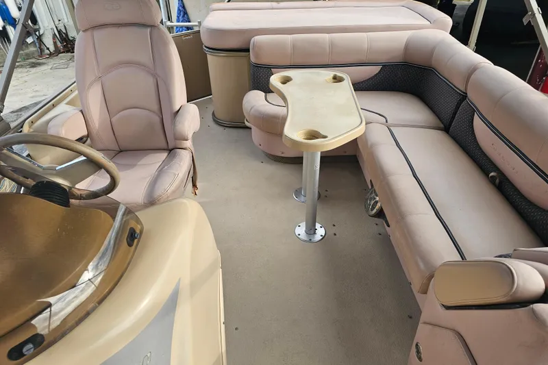 Slide: The Image of 2008 Sanpan 2200 RE-3 Gate pontoon boat interior with beige seating and table. - 11