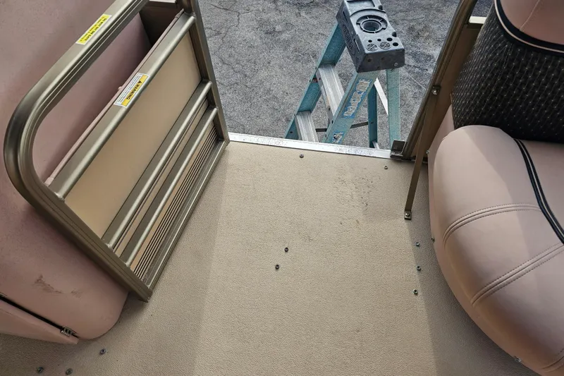 Slide: The Image of 2008 Sanpan 2200 RE-3 Gate interior with beige seating and metal gate. - 12