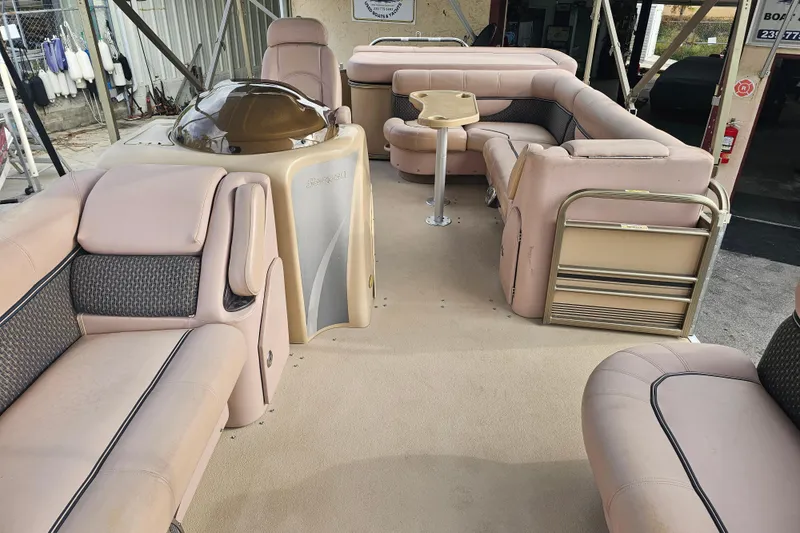 Slide: The Image of 2008 Sanpan 2200 RE-3 Gate pontoon boat interior with beige seating and helm. - 14