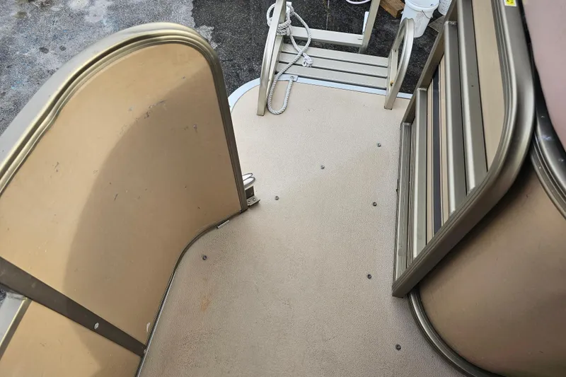 Slide: The Image of 2008 Sanpan 2200 RE-3 Gate boat interior with beige flooring and metal railings. - 16