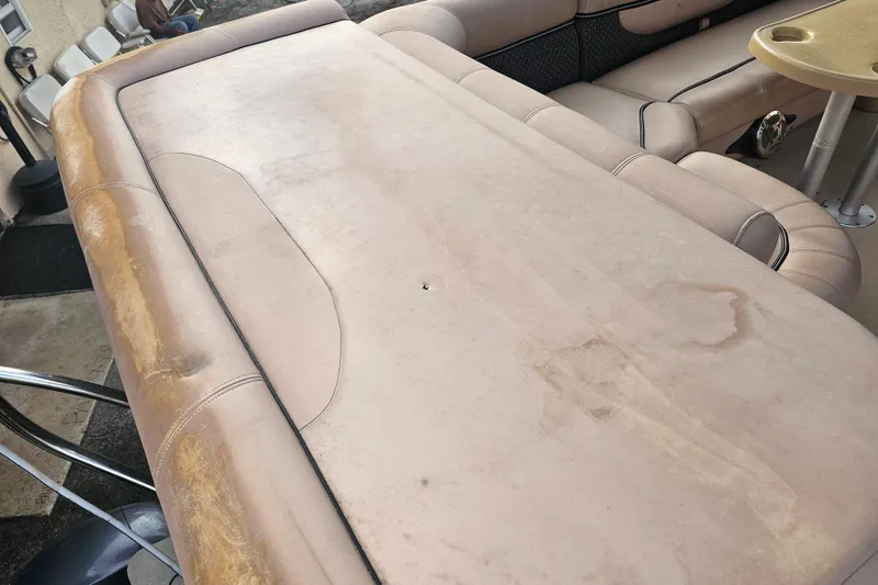 Slide: The Image of 2008 Sanpan 2200 RE-3 Gate boat interior with worn beige upholstery and seating area. - 17