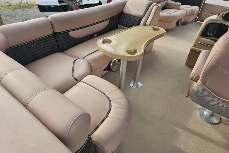 Slide: The Image of Interior of a 2008 Sanpan 2200 RE-3 Gate pontoon boat with beige seating and table. - 18