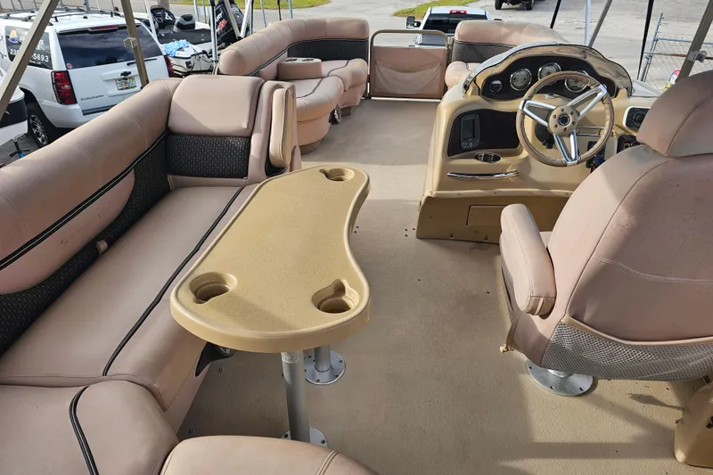 Slide: The Image of 2008 Sanpan 2200 RE-3 Gate pontoon boat interior with beige seating and steering console. - 19