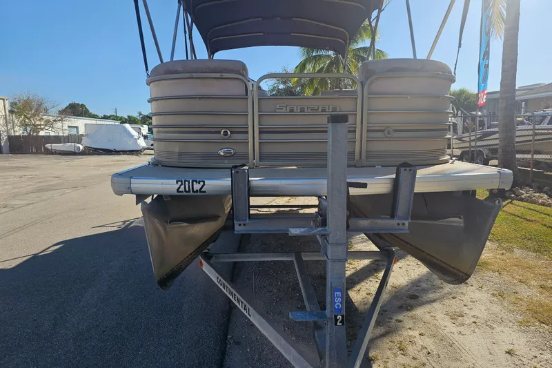 Slide: The Image of 2008 Sanpan 2200 RE-3 Gate pontoon boat on trailer, parked outdoors. - 2
