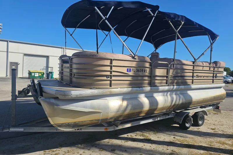 Slide: The Image of 2008 Sanpan 2200 RE-3 Gate pontoon boat on trailer, parked outdoors. - 3