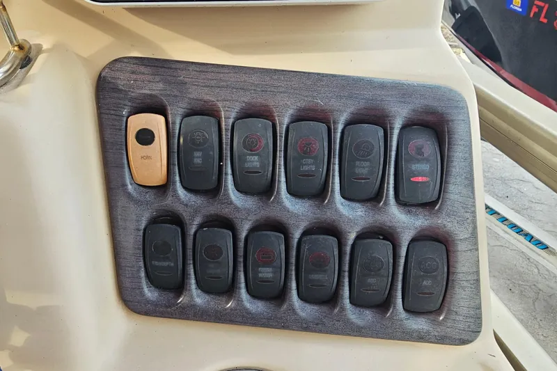 Slide: The Image of Control panel of a 2008 Sanpan 2200 RE-3 Gate boat with labeled switches. - 7