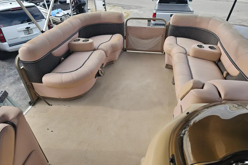 Slide: The Image of 2008 Sanpan 2200 RE-3 Gate pontoon boat interior with beige seating and cup holders. - 8