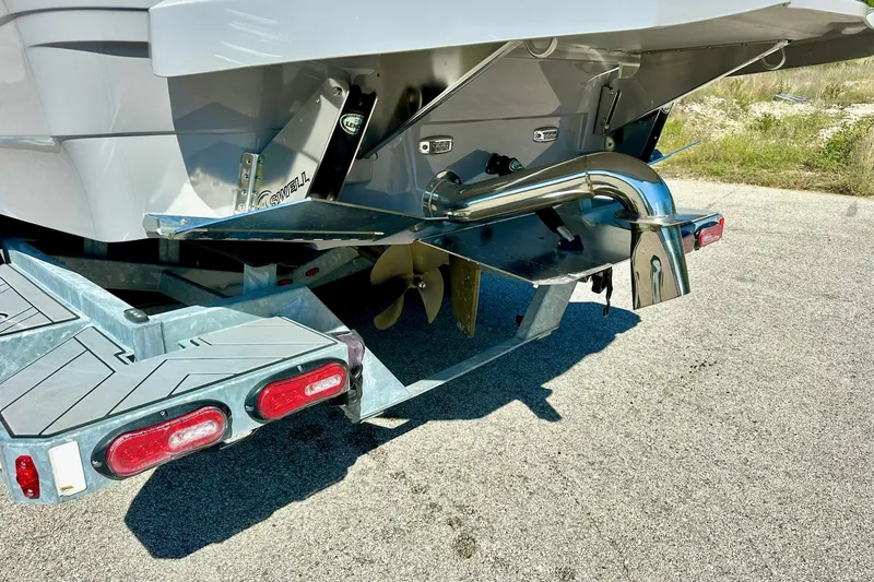 Slide: The Image of Rear view of 2020 Supra SE550 boat on trailer, showcasing propeller and exhaust system. - 15
