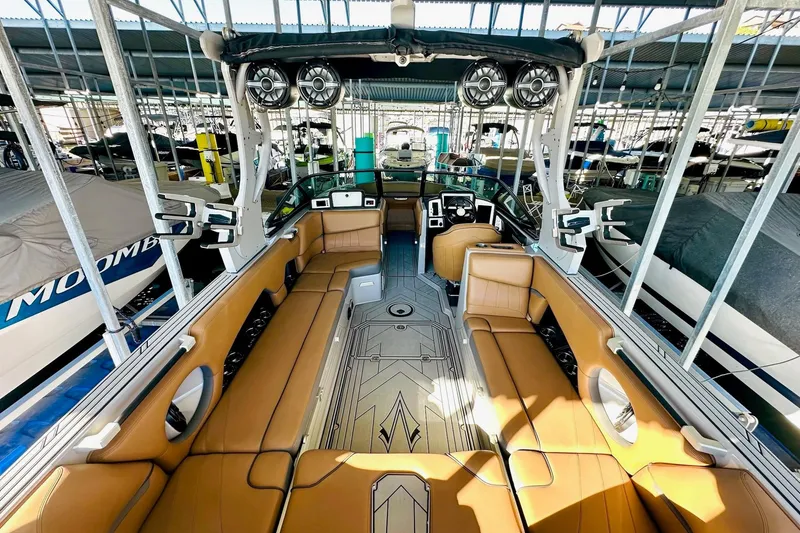 Slide: The Image of 2020 Supra SE550 boat interior with tan seating and advanced audio system. - 21