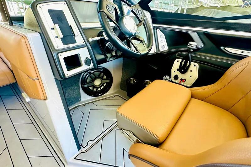 Slide: The Image of 2020 Supra SE550 boat interior with tan seats and modern dashboard controls. - 25