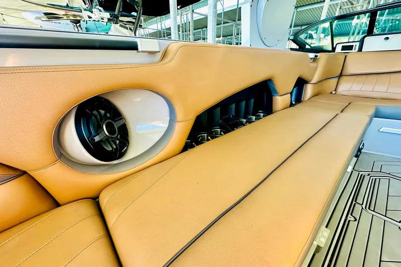 Slide: The Image of 2020 Supra SE550 boat interior with tan leather seating and built-in speaker system. - 26
