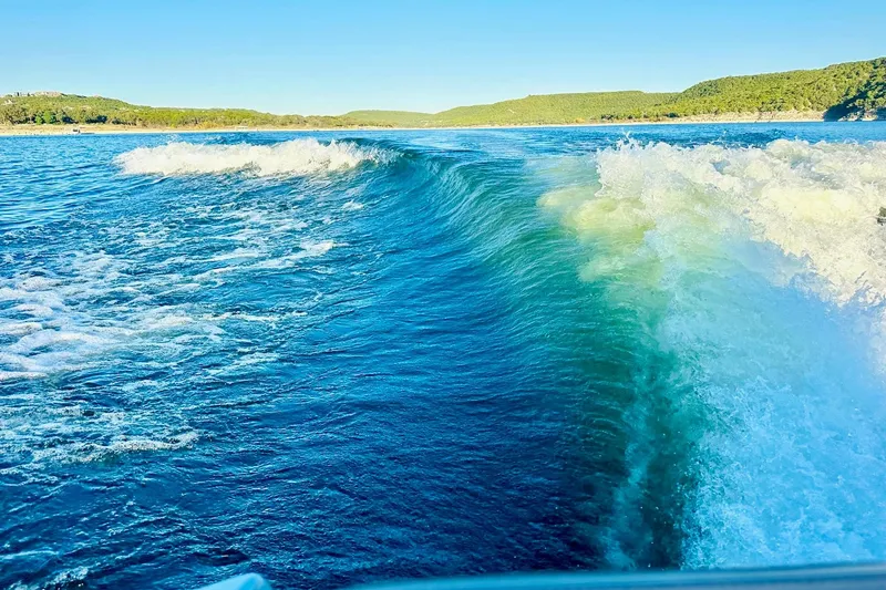Slide: The Image of Wake created by a 2020 Supra SE550 boat on a sunny lake. - 37