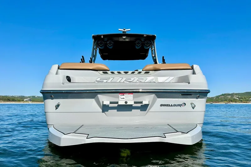 Slide: The Image of 2020 Supra SE550 boat on water, showcasing rear design and Swell Surf system. - 5