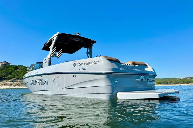 Slide: The Image of 2020 Supra SE550 boat on water under clear blue sky. - 8