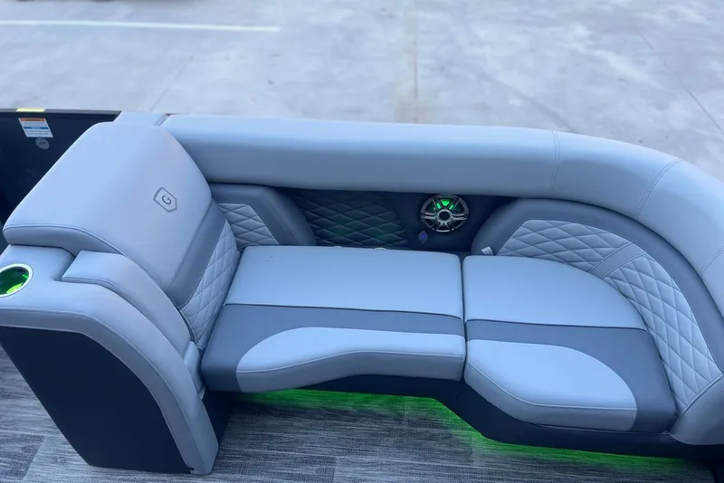 Slide: The Image of Luxurious seating on 2026 Godfrey Monaco 235 SFL boat with quilted upholstery and speaker. - 10