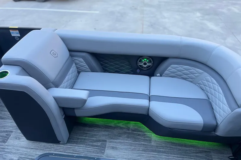 Slide: The Image of Luxurious seating on 2026 Godfrey Monaco 235 SFL boat with quilted upholstery and speaker. - 11