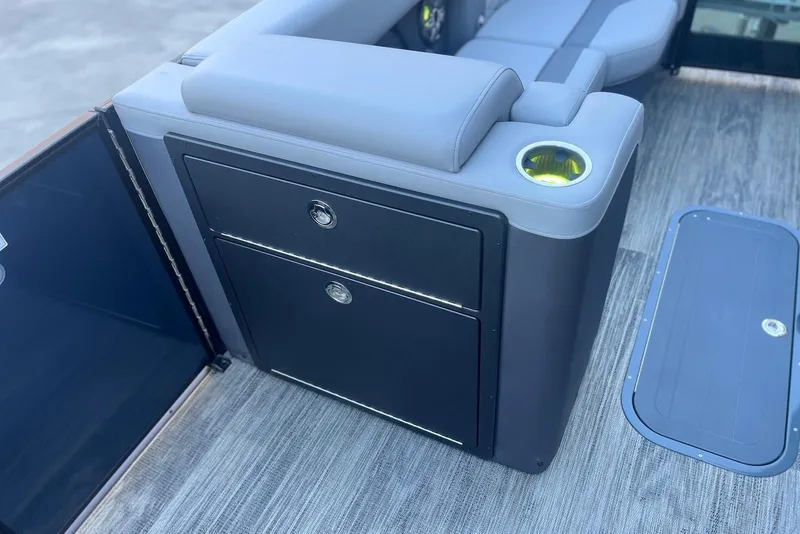 Slide: The Image of 2026 Godfrey Monaco 235 SFL interior with storage compartments and cup holder. - 14