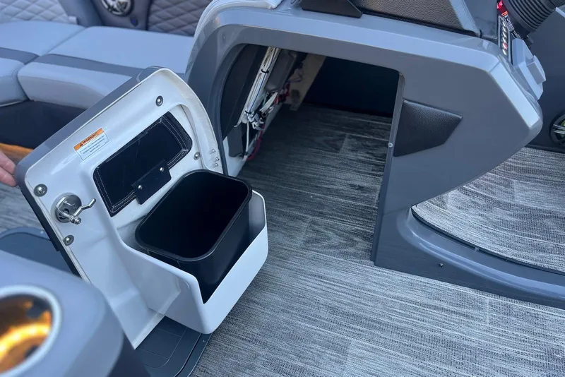 Slide: The Image of Interior of 2026 Godfrey Monaco 235 SFL boat showing storage compartment and seating. - 17