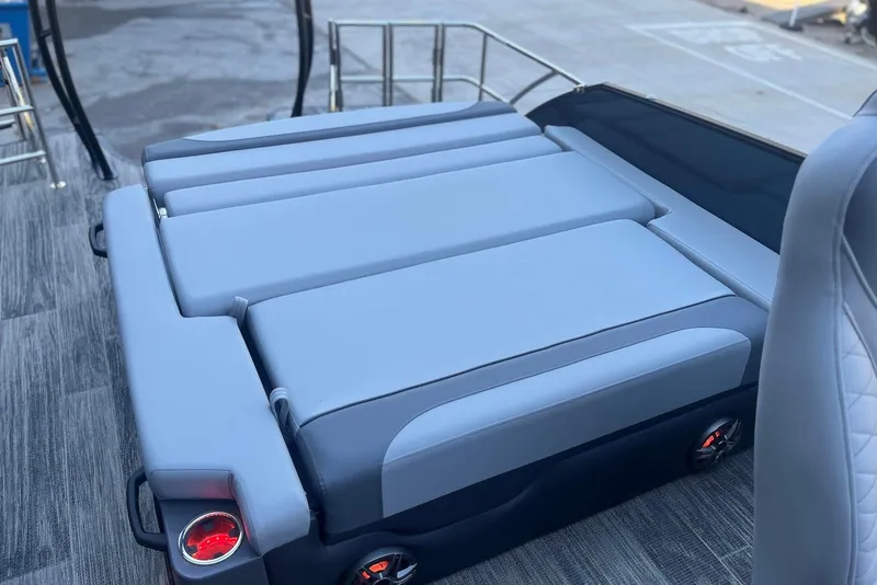 Slide: The Image of 2026 Godfrey Monaco 235 SFL boat interior with gray cushioned seating and cup holders. - 22