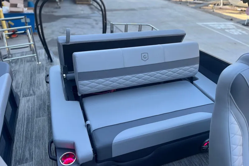 Slide: The Image of 2026 Godfrey Monaco 235 SFL boat interior with luxurious gray seating and cup holders. - 26