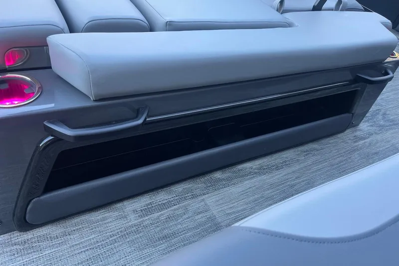 Slide: The Image of 2026 Godfrey Monaco 235 SFL boat interior with gray seating and pink-lit cup holders. - 28