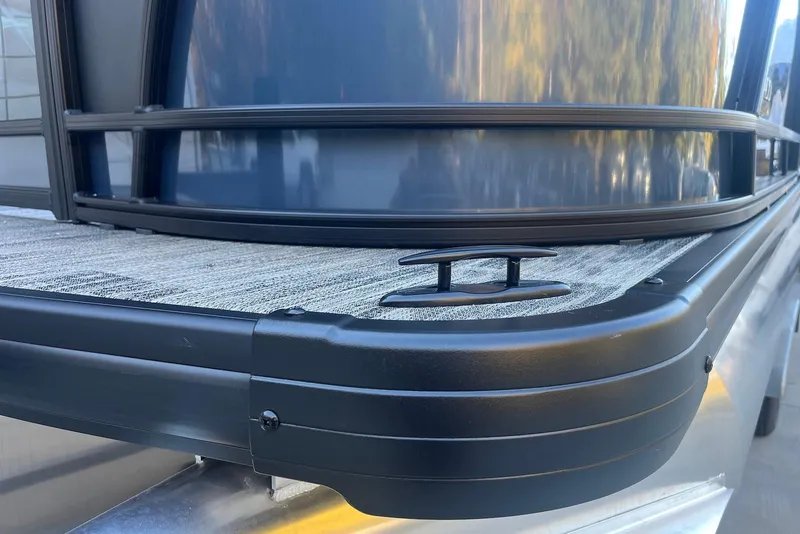 Slide: The Image of 2026 Godfrey Monaco 235 SFL boat deck with sleek black railing and cleat. - 34