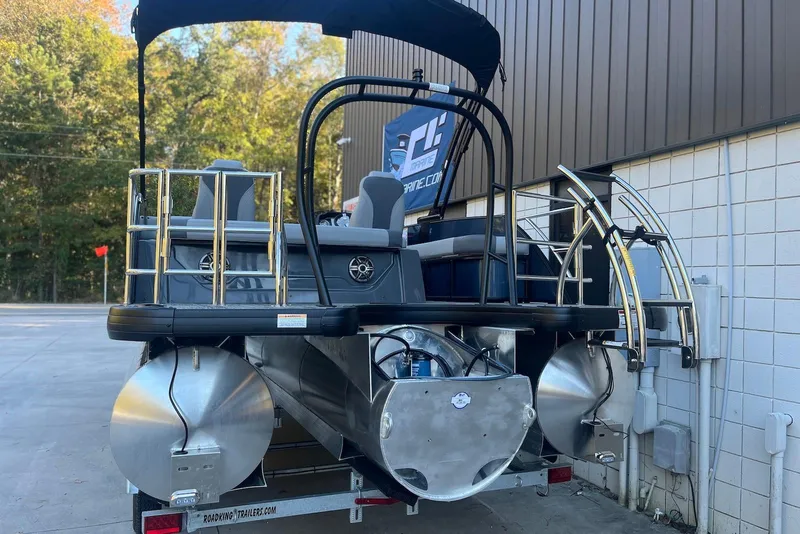 Slide: The Image of 2026 Godfrey Monaco 235 SFL pontoon boat, rear view, parked outdoors. - 4