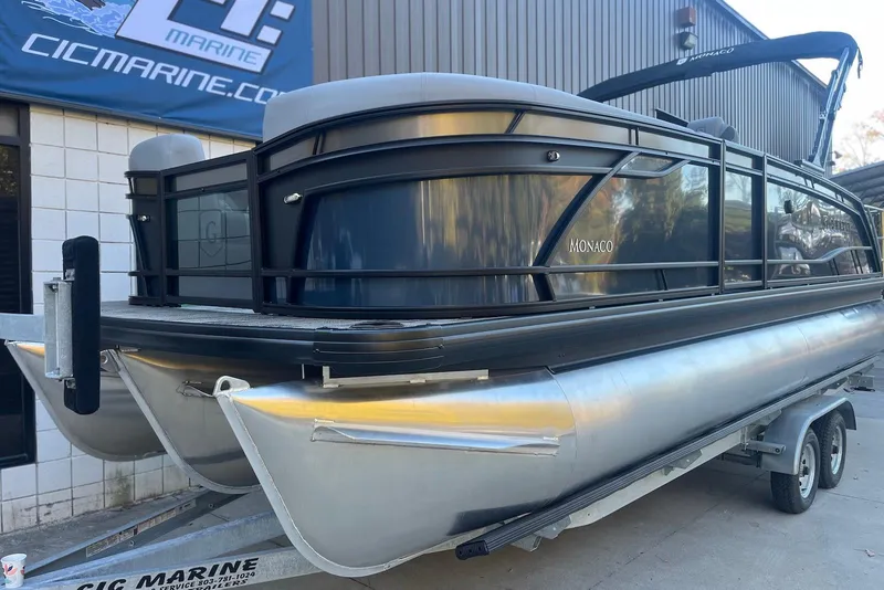 Slide: The Image of 2026 Godfrey Monaco 235 SFL pontoon boat on trailer at marine dealership. - 5